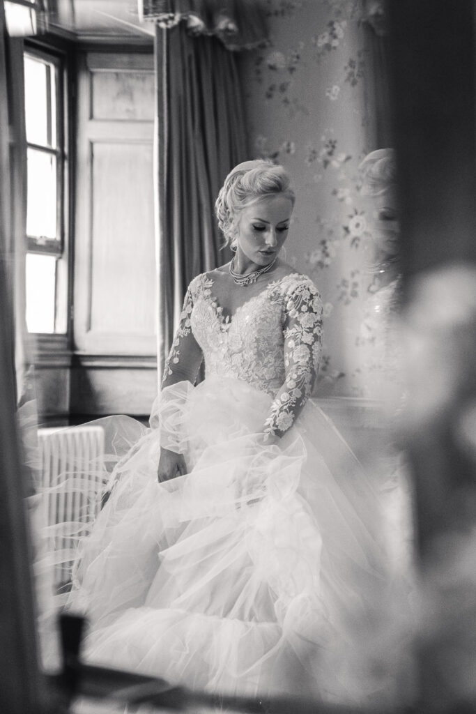 Bride getting ready reflected at Knowsley Hall