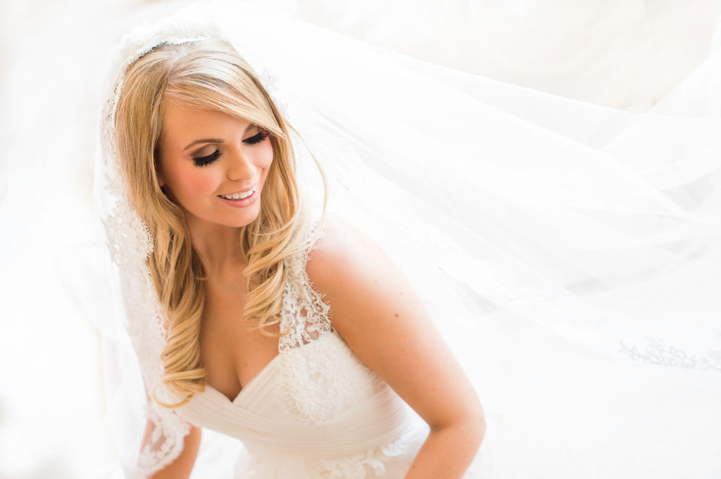 Bridal portrait in natural light with Cathedral veil flowing over left shoulder