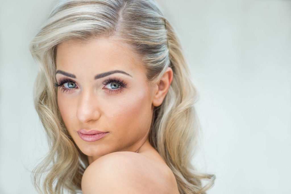 Bride portrait highlighting natural makeup look and simple flowing locks of hair