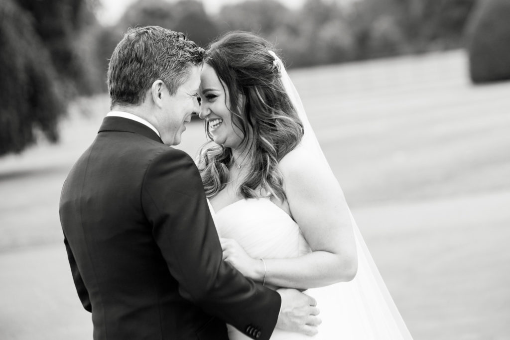 Happy couple laughing face to face having just married and enjoying some time alone