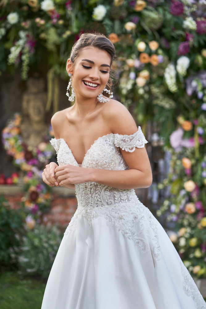bride portrait highlighting dress detail and floral decoration behind her