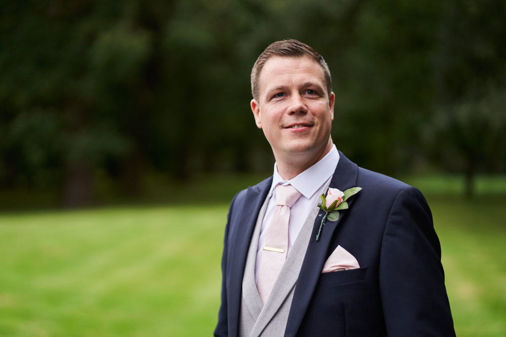 Portrait of groom taken in the garden just before guests begin to arrive