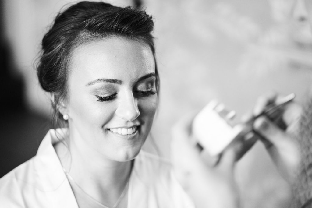 Finishing eye make up touches during morning preparations