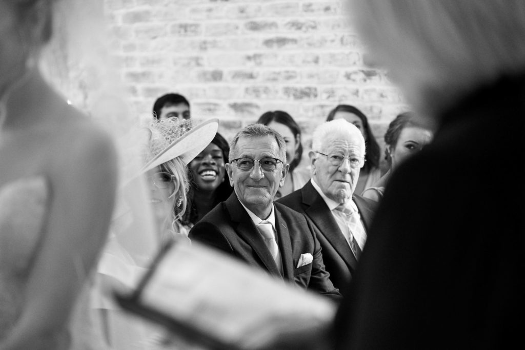 Candid picture of Father of the bride watching his daughter exchange her vows