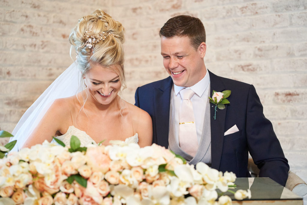 Bride and groom signing the official register