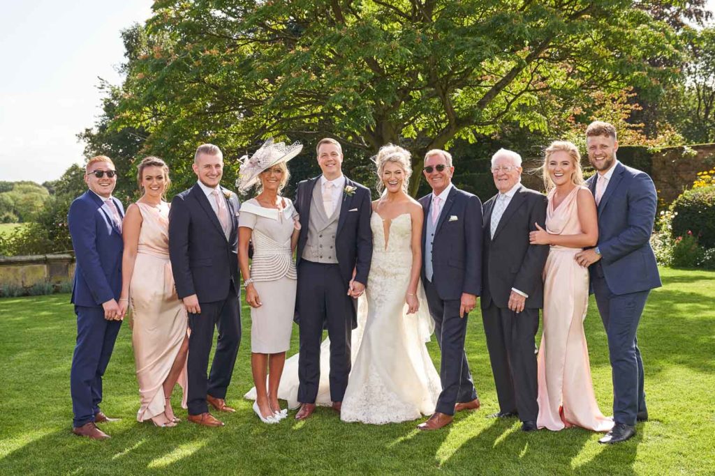 Bride and groom posed with Bride's family