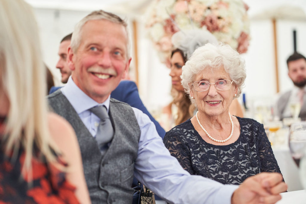 Grandmother enjoying the speeches during the wedding breakfast