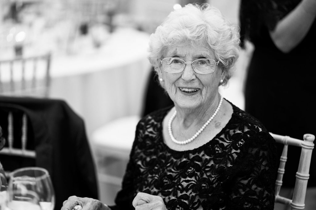 Grandmother caught with a beaming smile during the post dinner cocktails