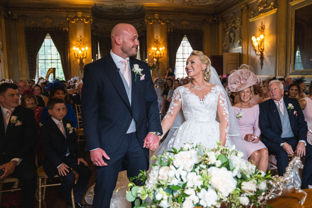 Wedding Ceremony with the couple smiling at each during their wedding vows