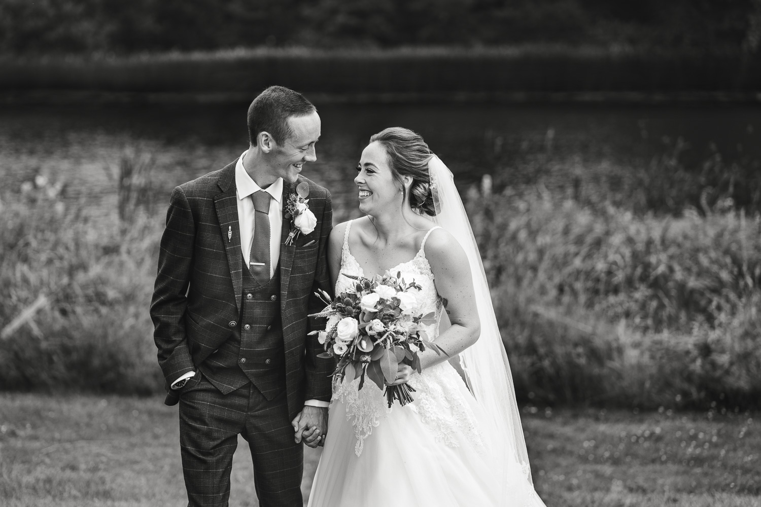 Bride and Groom laughing together in the grounds of Knowsley Hall