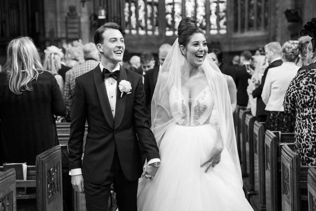 Beaming bride and groom during their recessional