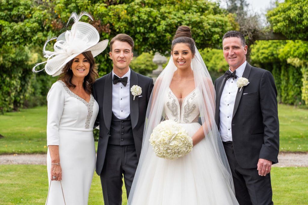 Newlyweds posed with parents either side