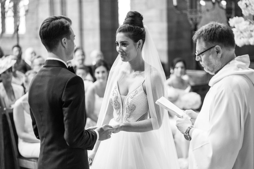 Groom placing the ring on his new wife's finger during the wedding ceremony