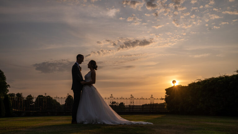 Bride & Groom silhouetted against the sunset